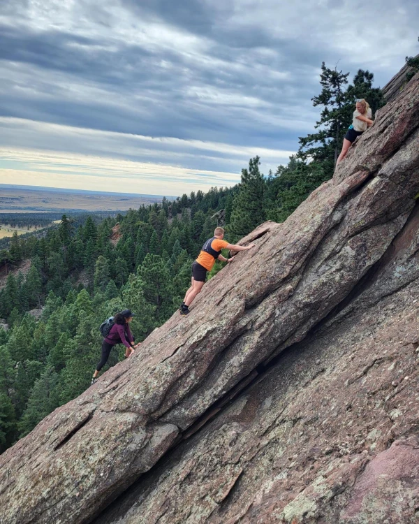 Three FIRST RF employees scrambling up the second flat iron.