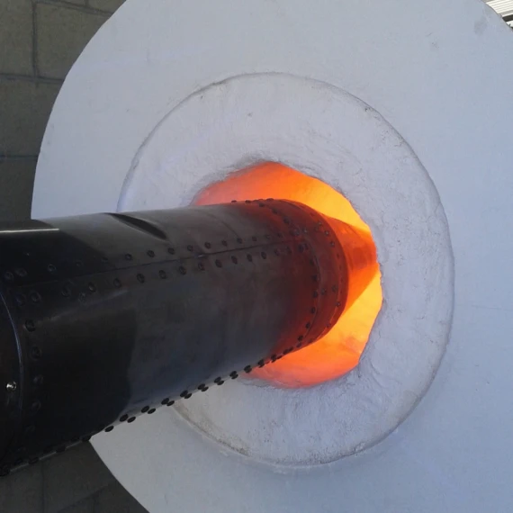 The tip of a missile is placed into a hot kiln portal. The inside of the kiln is glowing bright orange.