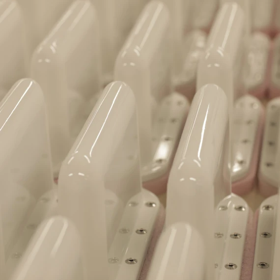 White conformal looking antennas lined up in rows.