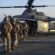 U.S. marines loading onto an AH-1Z Viper attack helicopter that sits on the flight deck aboard the amphibious dock landing ship USS Pearl Harbor (LSD 52).