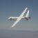 NASA's MQ-9 Predator banking in a blue sky with mountains in the background.